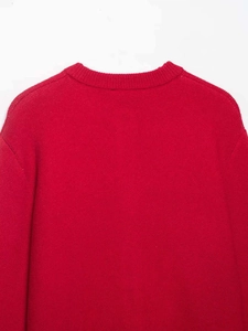 Detail view of the red crew neck knit cardigan showing delicate fabric texture and back collar