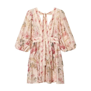 Detail of pink floral mini dress with puff sleeves and layered ruffle hem