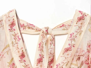 Detail of floral print chiffon dress featuring an elegant back neck tie closure