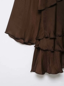Detailed macro view of dark brown satin tiered ruffles on a stylish summer mini dress