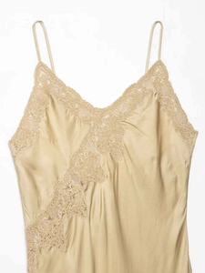 Détail de la robe en satin champagne avec bordure en dentelle fine sur le col en V