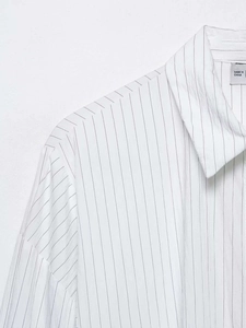 Close-up detail of white striped cotton shirt collar with Made in China tag