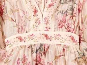 Detail of floral embroidery on the waist of a minimalist summer V-neck dress
