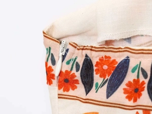 Detail view of high-quality invisible zipper on a floral cotton-linen summer dress