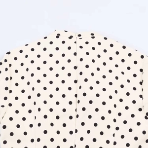 Detail of invisible back zipper on a polka dot summer dress with high-quality stitching