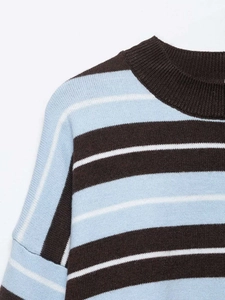Detailed view of the striped knit sweater featuring a ribbed crew neck and soft texture