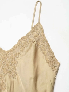 Vue détaillée du caraco en satin champagne avec dentelle délicate sur le col en V