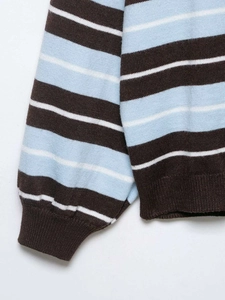 Detail of blue and brown striped knit sweater with ribbed cuffs and textured finish