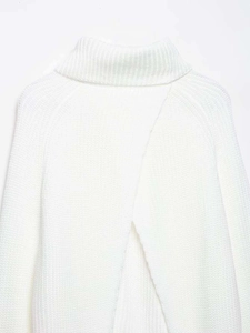 Detail of white high-neck knit sweater featuring a unique overlapping split back design