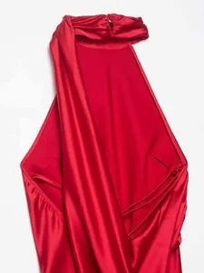 Close-up of a red halter neck satin maxi dress showing backless cut and pleated silk texture