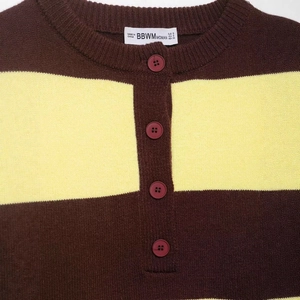 Brown and yellow striped knit sweater with red button neckline and detailed logo label