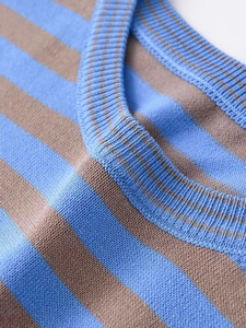 Close-up of blue and brown striped knitwear showing ribbed neckline and fabric texture