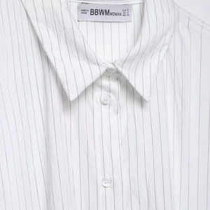 Minimalist white pinstripe button-down shirt with classic collar and fine cotton texture