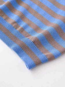 Close-up of blue and brown striped knit fabric with ribbed hem detail and fine texture