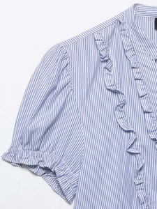 Detail of blue and white vertical stripes with ruffles on the short sleeve shirt