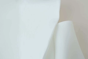 Detailed close-up showing the fine woven fabric texture of a white commuter style blazer