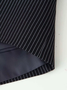 Detail shot of navy pinstripe fabric with premium gray-blue lining and fine stitching