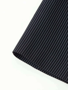 Macro shot of dark pinstripe fabric showing fine twill texture and smooth drape material