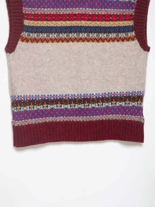 Detailed close-up of Fair Isle jacquard patterns and red ribbed hem on knit vest