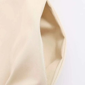 Close-up of beige high-density cotton twill fabric and premium stitching detail