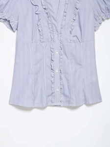 Detail of V-neck ruffle trim and blue white vertical stripes on a short sleeve summer shirt