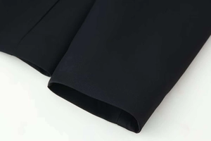 Detail shot of black blazer sleeve cuffs showing premium stitching and fabric texture