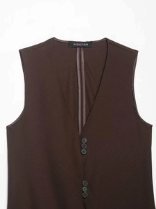Detail view of the V-neck brown vest featuring button embellishments and refined fabric