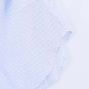 Detailed view of the blue striped shirt showing high-quality stitching and curved hem