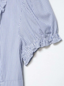 Detailed view of blue and white striped blouse featuring ruffled puff sleeves and soft cotton