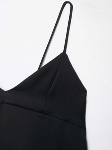 Detail shot of black V-neck camisole with thin straps and premium textured fabric