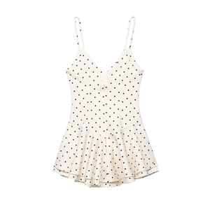 Polka dot white slip dress featuring a V-neckline and tiered ruffle hem design