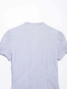 Detail view of blue and white striped short puff sleeves and back waist seam on V-neck shirt