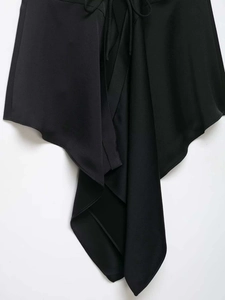 Detail showing the jagged asymmetric hemline and drawstring waist on black v-neck top