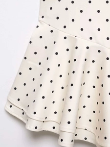 Detail of white polka dot fabric with ruffled layers and elegant woven texture