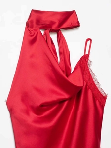 Close-up of red satin halter top with lace trim and elegant draped neckline detail