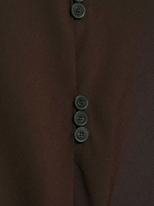 Macro shot of dark brown fabric texture and classic four-hole resin buttons on a vest