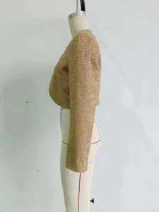 Side view of short golden tweed jacket with metallic threads on mannequin