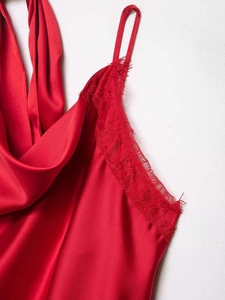 Close-up of red satin halter top featuring delicate eyelash lace trim and fine silk texture