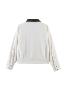 Back view of cream corduroy jacket with contrast brown leather collar and ribbed texture