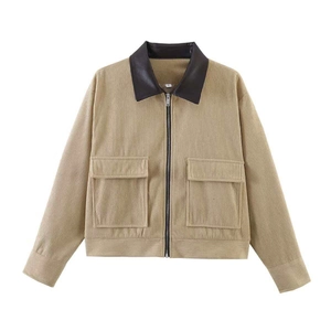 Detail of khaki corduroy jacket showing contrast black leather collar and zip closure