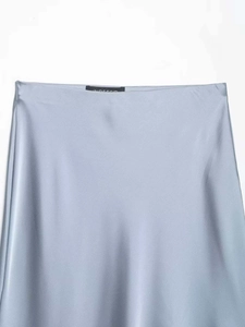 Macro detail of the smooth light blue satin fabric and waistband on this midi skirt