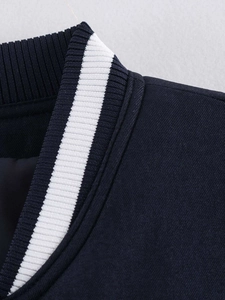 Macro detail of navy blue jacket collar with white ribbed knit stripes and textured fabric