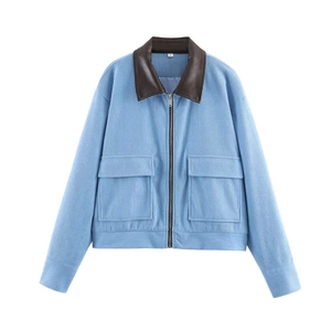 Detail of light blue corduroy jacket with dark brown faux leather collar and front pockets