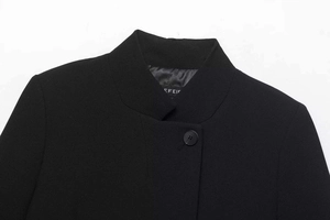 Detailed view of standing collar and brand label on a black slim fit blazer