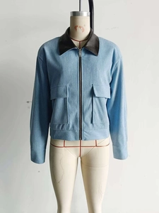 Close-up of light blue corduroy jacket with contrast brown faux leather collar detail