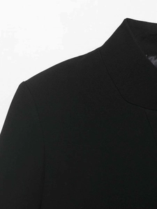 Detail of high-quality black stand collar blazer showing precise stitching and fabric texture