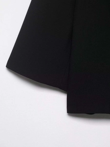 Macro detail of the high-quality woven fabric and neat stitching on a black blazer sleeve