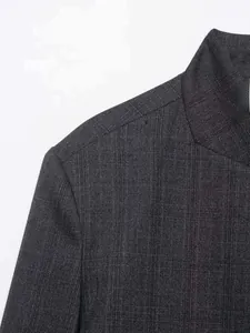 Detail of dark grey blended blazer fabric featuring vertical stripes and premium stitching