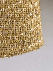 Detail of golden tweed fabric with iridescent sequins and metallic fringe threads