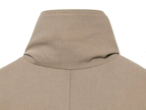Macro detail of khaki twill jacket featuring stand collar and reinforced double stitching